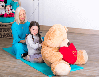 Teacher with young child doing the Story Massage Programme