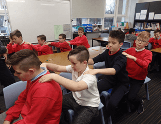 Boys doing Story Massage in a classroom